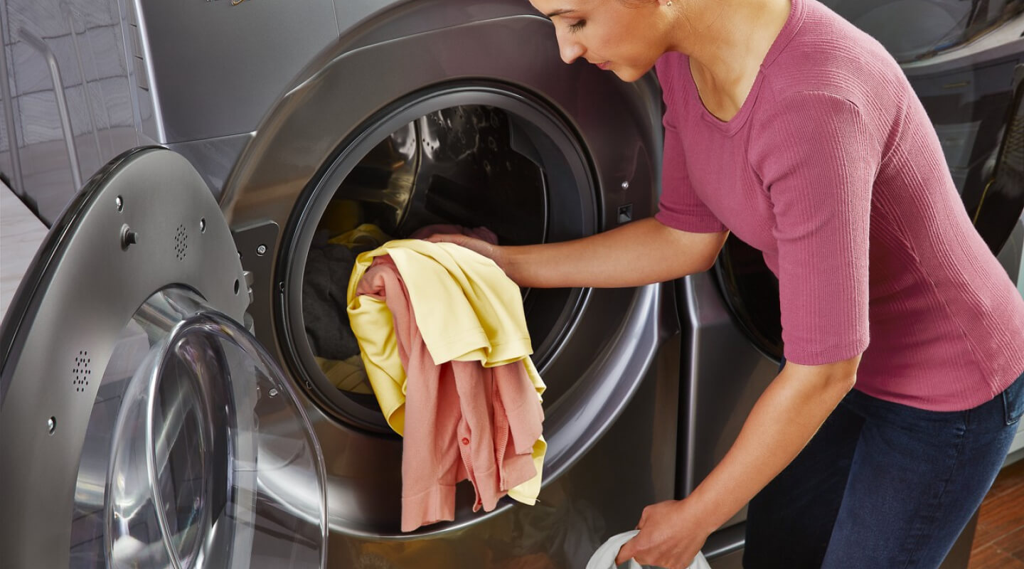 Person removing clothes from a dryer