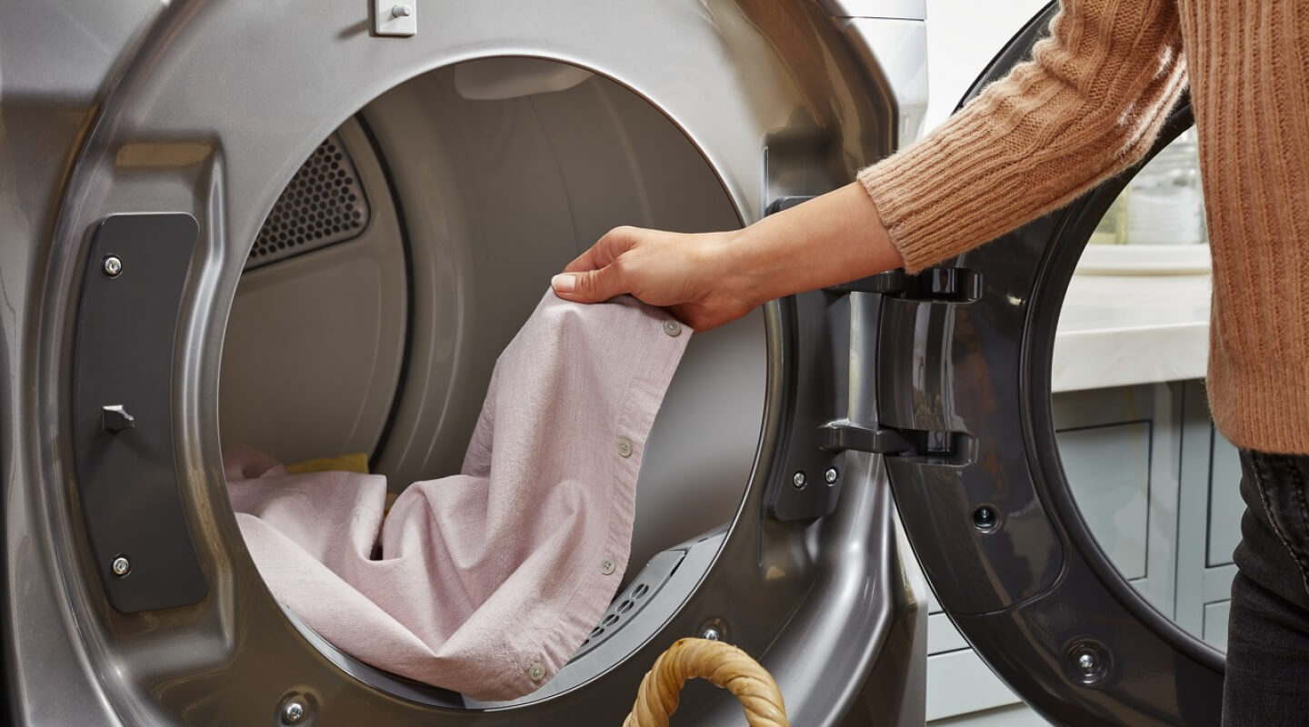 Person removing clothes from a dryer