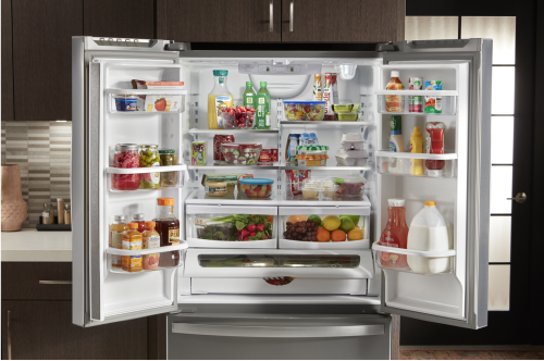 Side-by-side refrigerator doors open with a mix of colorful groceries inside