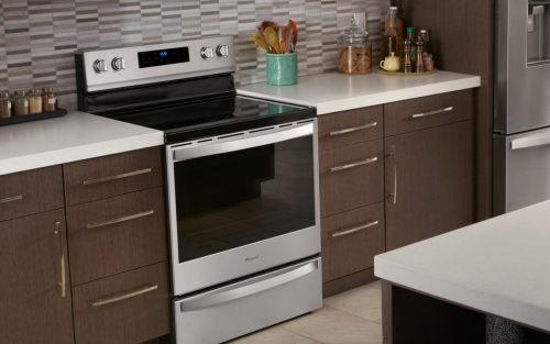 Whirlpool® Electric Range set in brown cabinetry