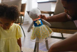 A person holding a stuffed animal