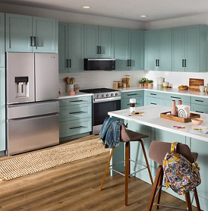 A kitchen with Whirlpool® Appliances and teal cabinets.