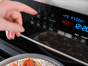 A person selecting Frozen Bake on a control panel