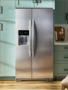 A Whirlpool® Side-by-Side Refrigerator installed within teal cabinets